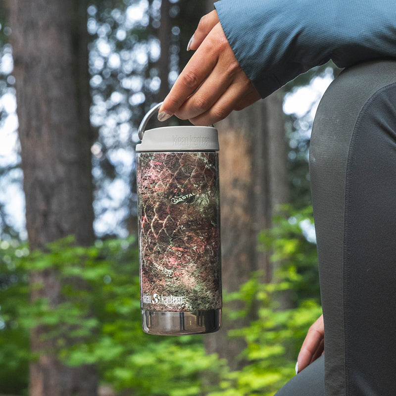 12oz-tkwide-with-cafe-cap-mossy-oak-p6 12oz_tumbler_mossyoak_rainbowtrout_hand_closeup_square.jpg