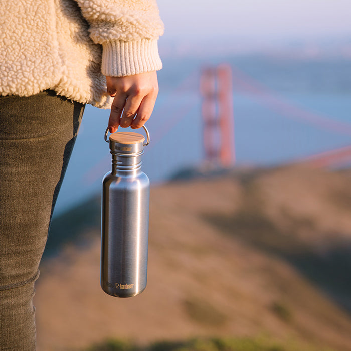 27oz-reflect-with-bamboo-cap-h3 K27SSLRF-BS-BAMBOO_reflect_bottle_bridge_lifestyle.jpg